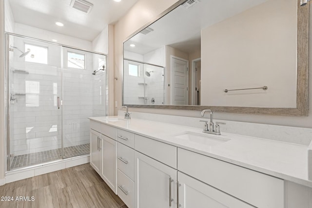 bathroom with vanity and an enclosed shower