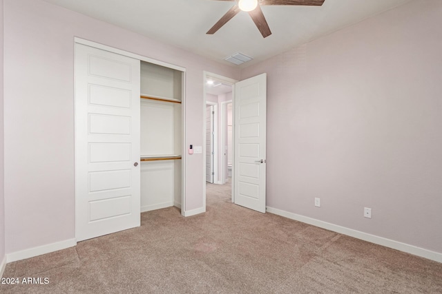 unfurnished bedroom featuring carpet, ceiling fan, and a closet