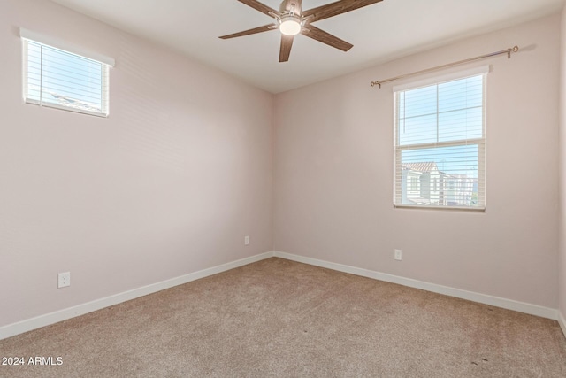 carpeted spare room with ceiling fan