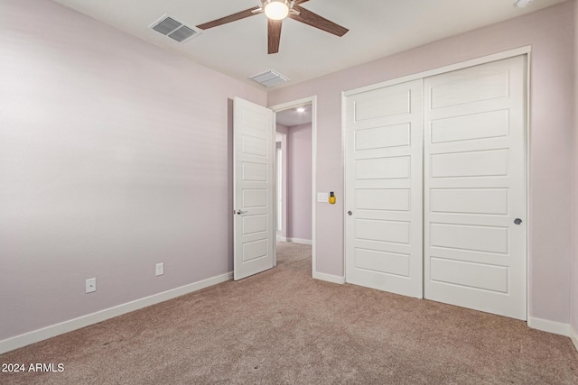 unfurnished bedroom featuring ceiling fan, a closet, and carpet floors