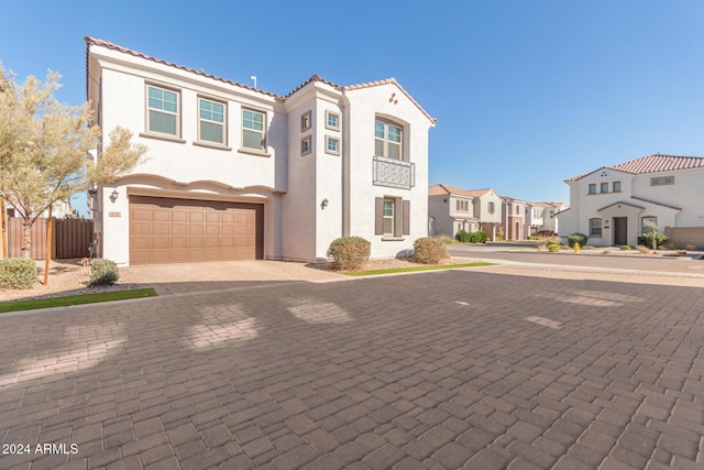 mediterranean / spanish home featuring a garage