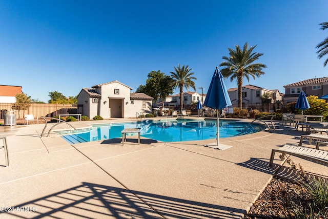 view of swimming pool with central air condition unit and a patio area