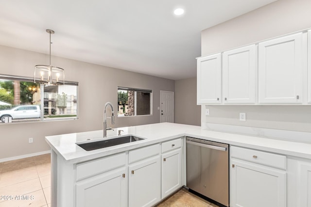 kitchen featuring pendant lighting, dishwasher, kitchen peninsula, sink, and white cabinetry