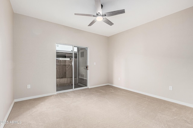 carpeted spare room featuring ceiling fan