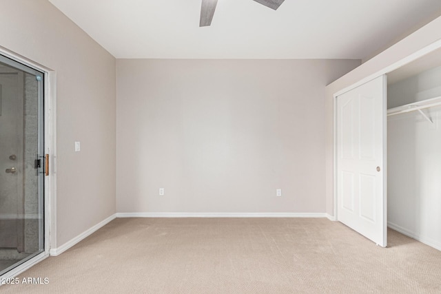 unfurnished bedroom featuring light carpet, a closet, and ceiling fan