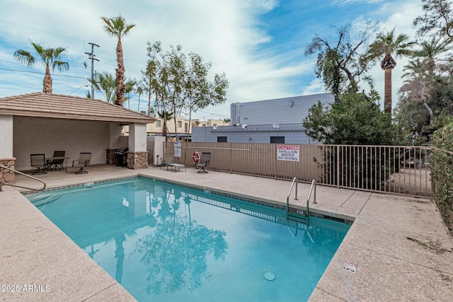 view of swimming pool featuring a patio area