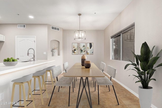 dining room featuring a notable chandelier and sink