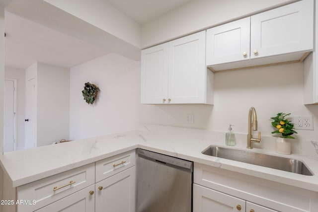909 S Acapulco Ln Unit A, Tempe, AZ 85281 - kitchen with stainless steel dishwasher, a sink, a peninsula, white cabinetry, and light stone counters