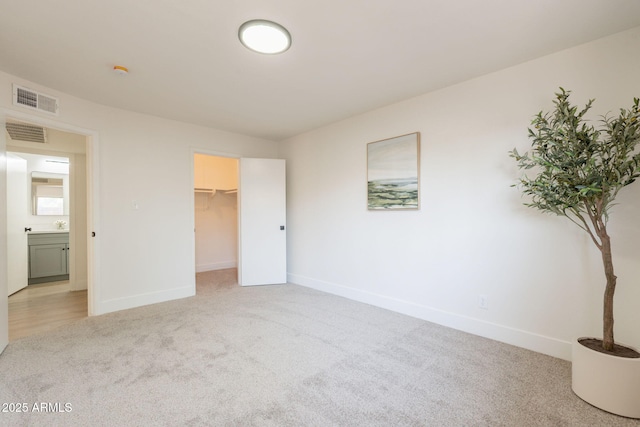 909 S Acapulco Ln Unit A, Tempe, AZ 85281 - unfurnished bedroom with light colored carpet, baseboards, and a spacious closet
