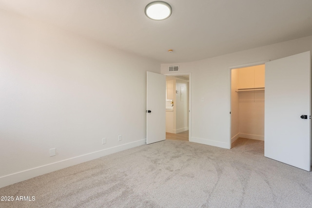 909 S Acapulco Ln Unit A, Tempe, AZ 85281 - unfurnished bedroom with light carpet, baseboards, and a spacious closet