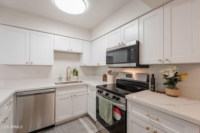 909 S Acapulco Ln Unit A, Tempe, AZ 85281 - kitchen featuring appliances with stainless steel finishes, a sink, white cabinetry, and light stone counters