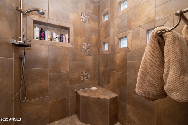 bathroom with tiled shower