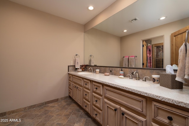 bathroom with vanity and backsplash