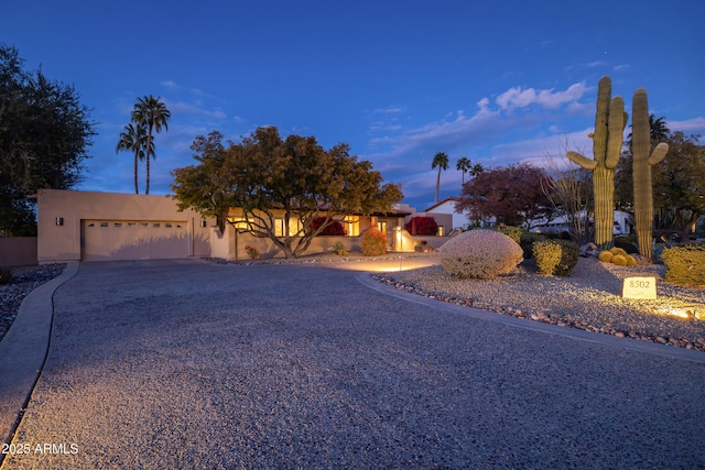 pueblo-style house with a garage