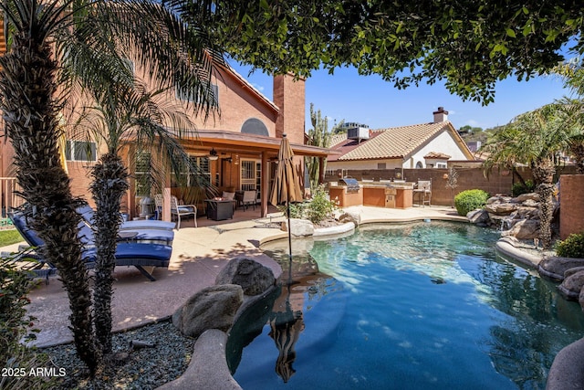 1633 W Acoma Dr, Phoenix, AZ 85023 - view of swimming pool with a fenced in pool, exterior kitchen, a patio area, ceiling fan, and fence