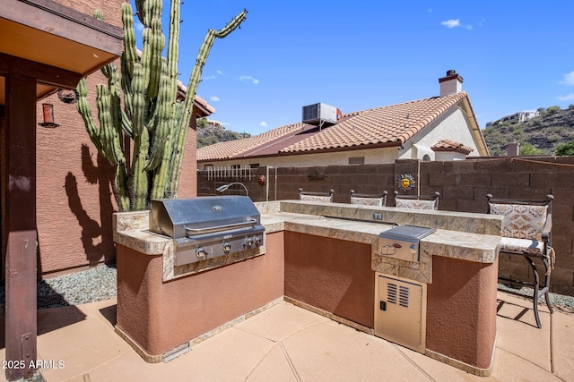 1633 W Acoma Dr, Phoenix, AZ 85023 - view of patio / terrace with fence, grilling area, central AC, and an outdoor kitchen