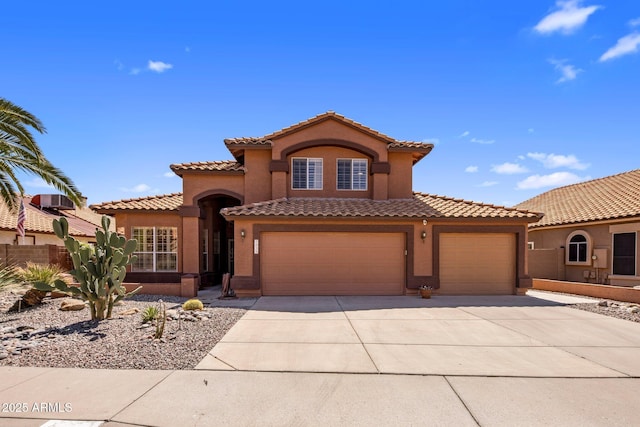 1633 W Acoma Dr, Phoenix, AZ 85023 - mediterranean / spanish-style home featuring a garage, driveway, a tiled roof, stucco siding, and fence