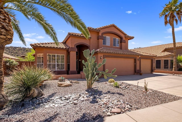 1633 W Acoma Dr, Phoenix, AZ 85023 - mediterranean / spanish home with stucco siding, a tiled roof, concrete driveway, an attached garage, and fence