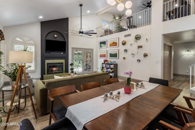 1633 W Acoma Dr, Phoenix, AZ 85023 - dining space with a large fireplace, ceiling fan, a wealth of natural light, and light wood-style floors