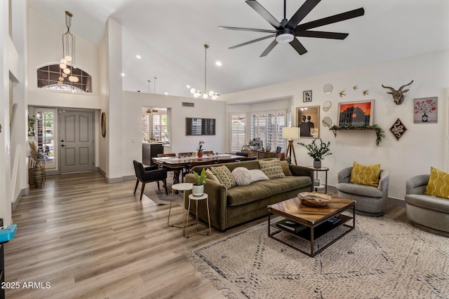 1633 W Acoma Dr, Phoenix, AZ 85023 - living room with a wealth of natural light, light wood-style floors, baseboards, high vaulted ceiling, and a ceiling fan