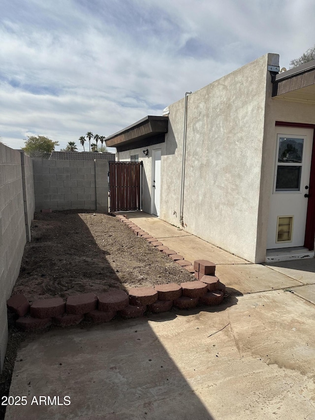 view of yard with a gate, a patio area, and fence