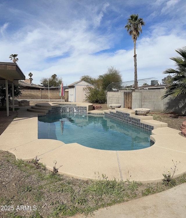 view of pool with an outbuilding, a fenced backyard, a storage shed, a fenced in pool, and a patio area