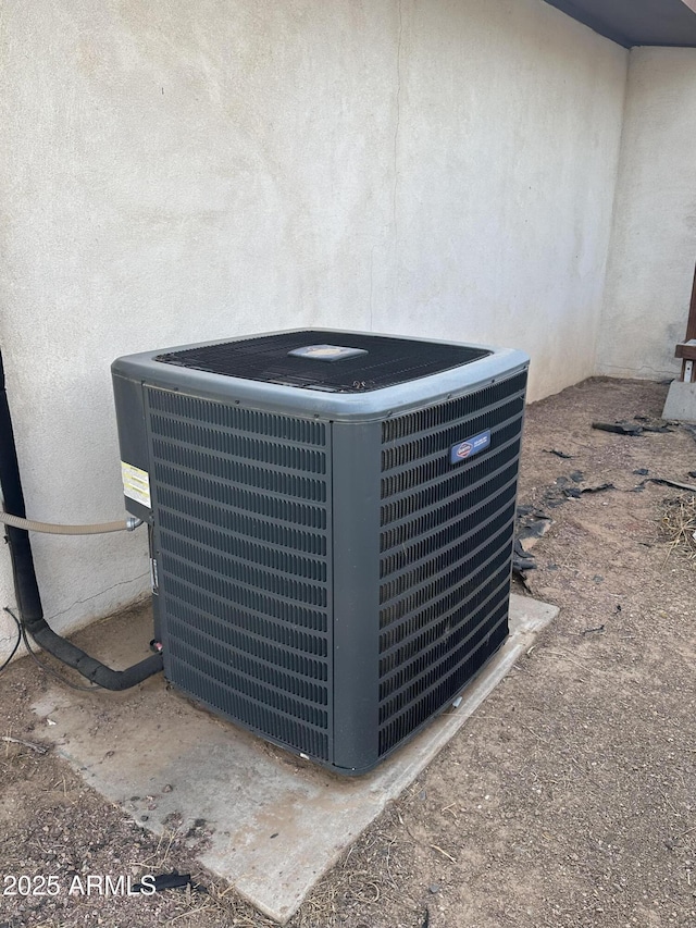 details with stucco siding and central air condition unit