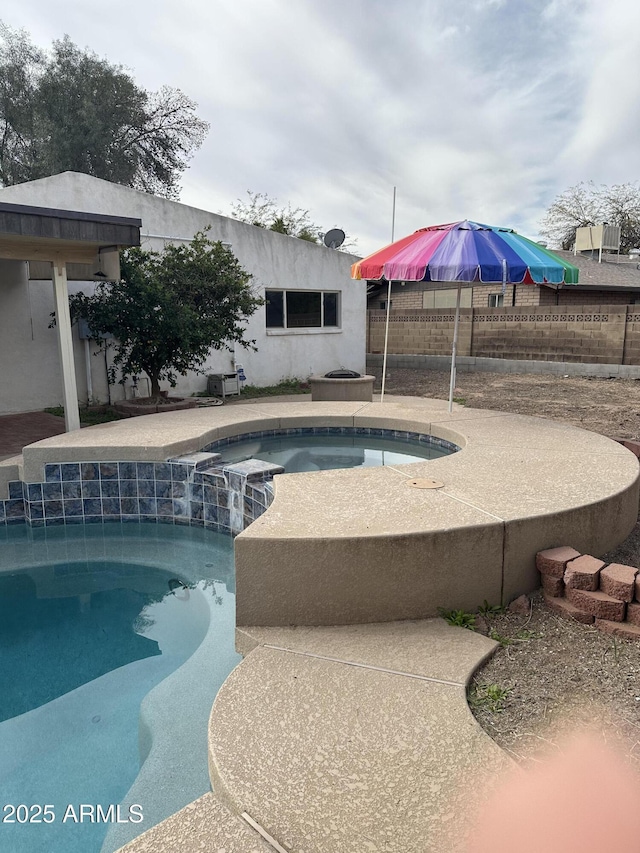 view of pool featuring a pool with connected hot tub and a patio