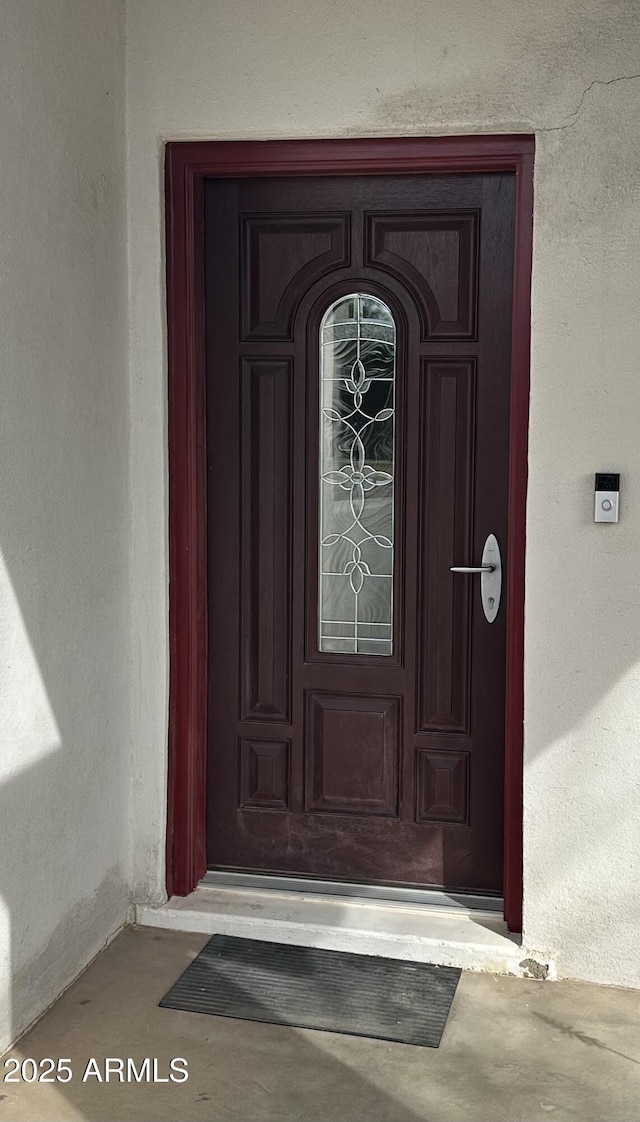 property entrance with stucco siding