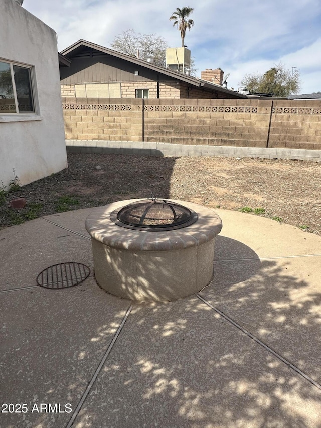 view of patio / terrace with fence and a fire pit