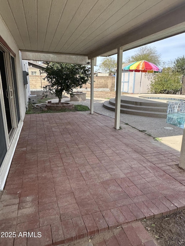 view of patio / terrace with a fenced backyard and an outdoor hot tub