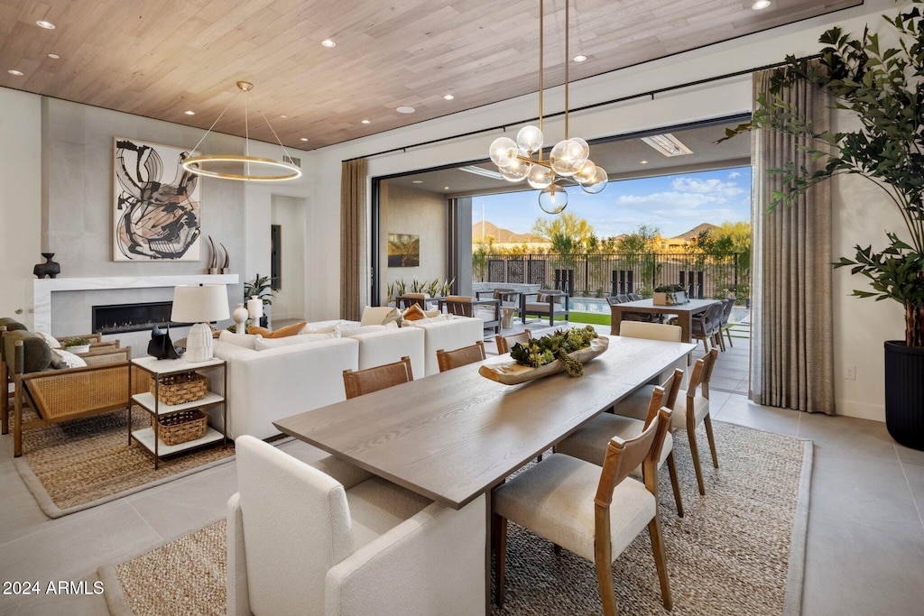 dining area featuring an inviting chandelier and wood ceiling