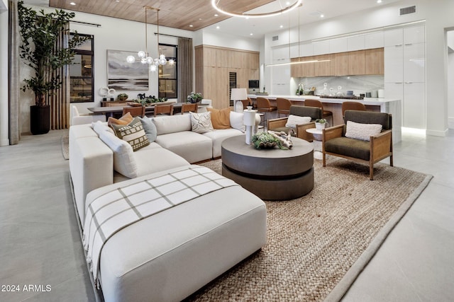 living room featuring a chandelier and wood ceiling