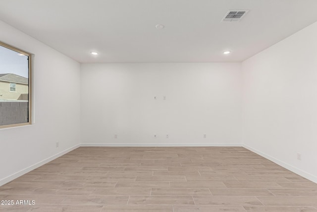 empty room with light hardwood / wood-style floors