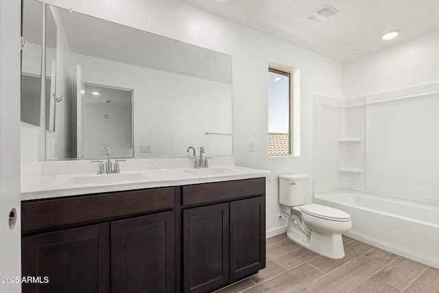 full bathroom with vanity, shower / bathtub combination, and toilet