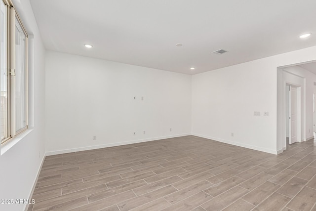 unfurnished room with light hardwood / wood-style flooring