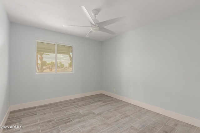 unfurnished room with wood finish floors, baseboards, and a ceiling fan