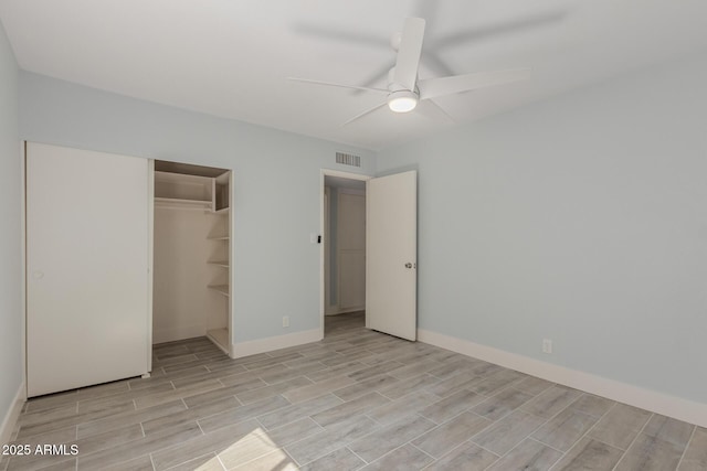 unfurnished bedroom with visible vents, ceiling fan, baseboards, wood tiled floor, and a closet