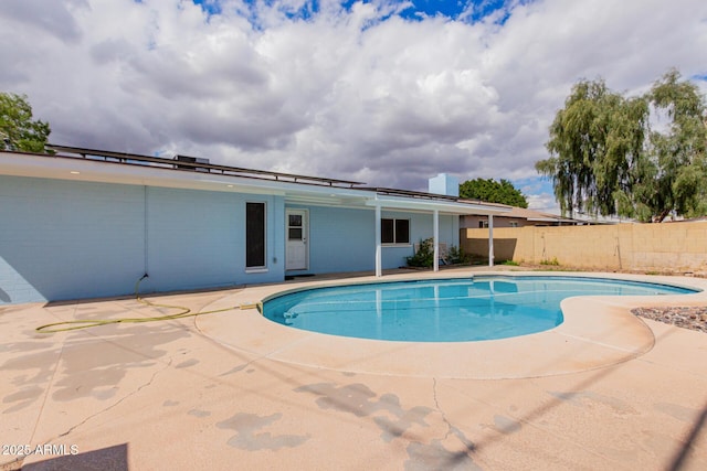 view of swimming pool with a fenced in pool, a patio, and fence