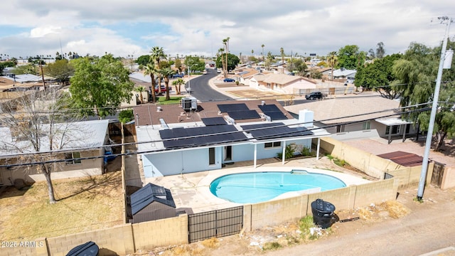 view of swimming pool with a fenced in pool, a patio, a residential view, and a fenced backyard