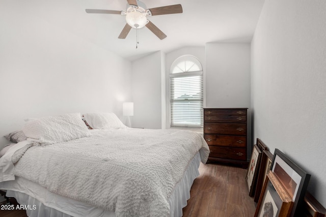 bedroom featuring ceiling fan, dark hardwood / wood-style flooring, and lofted ceiling