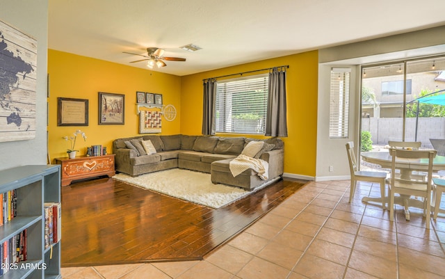 1697 E Linda Ln, Gilbert, AZ 85234 - living area with a ceiling fan, healthy amount of natural light, wood finished floors, and baseboards