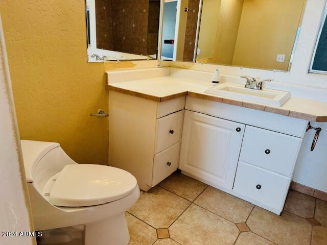 bathroom with vanity, toilet, and tile patterned flooring