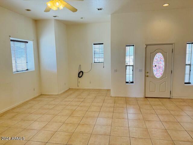 entryway featuring ceiling fan and light tile patterned floors