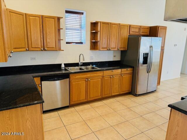 kitchen with stainless steel appliances, sink, and light tile patterned floors