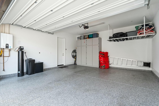 38500 N School House Rd Unit 62, Cave Creek, AZ 85331 - garage with a garage door opener, tankless water heater, and baseboards