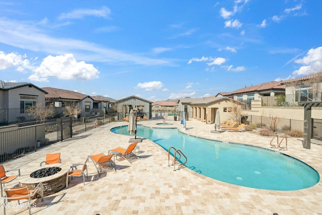 38500 N School House Rd Unit 62, Cave Creek, AZ 85331 - pool featuring fence, a community hot tub, a fire pit, a patio area, and a residential view