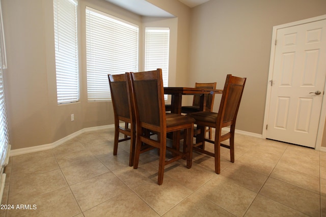 dining room featuring a wealth of natural light and light tile patterned flooring