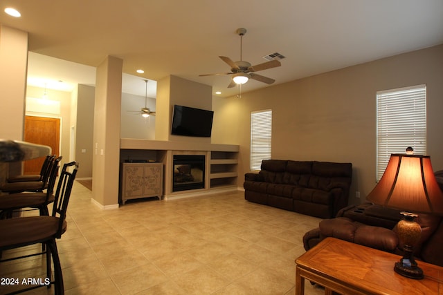 tiled living room featuring ceiling fan