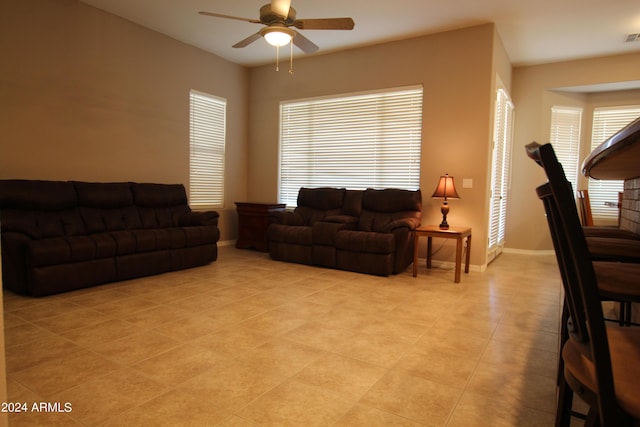 living room featuring ceiling fan and light tile patterned flooring